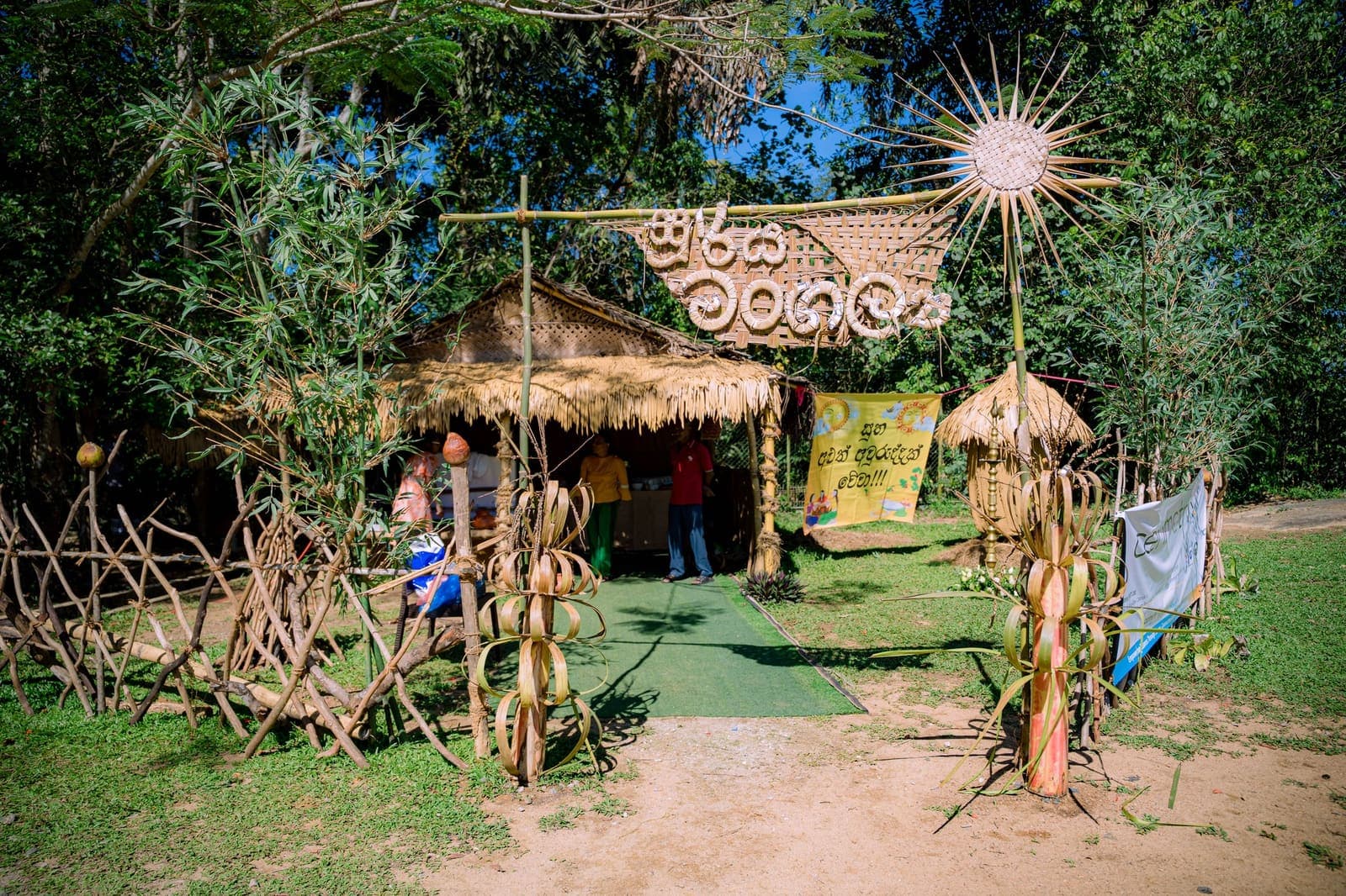 A thatched hut decorated for the Awurudu day out, among the trees