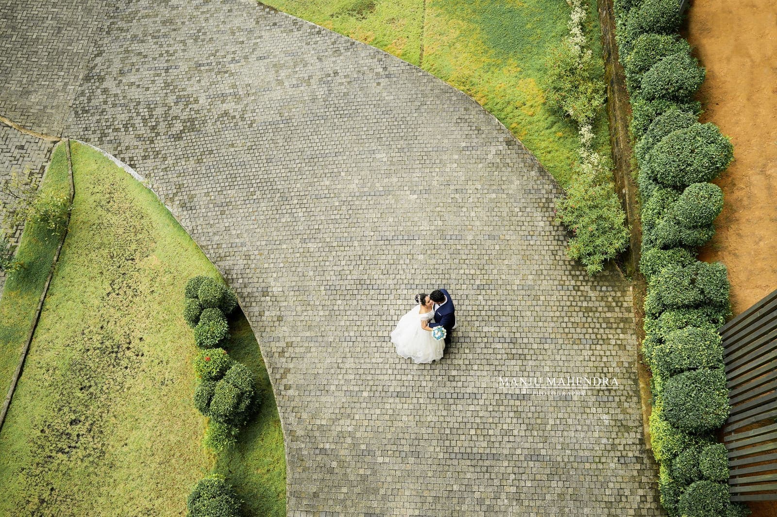 A curving garden path with hedges, seen from above
