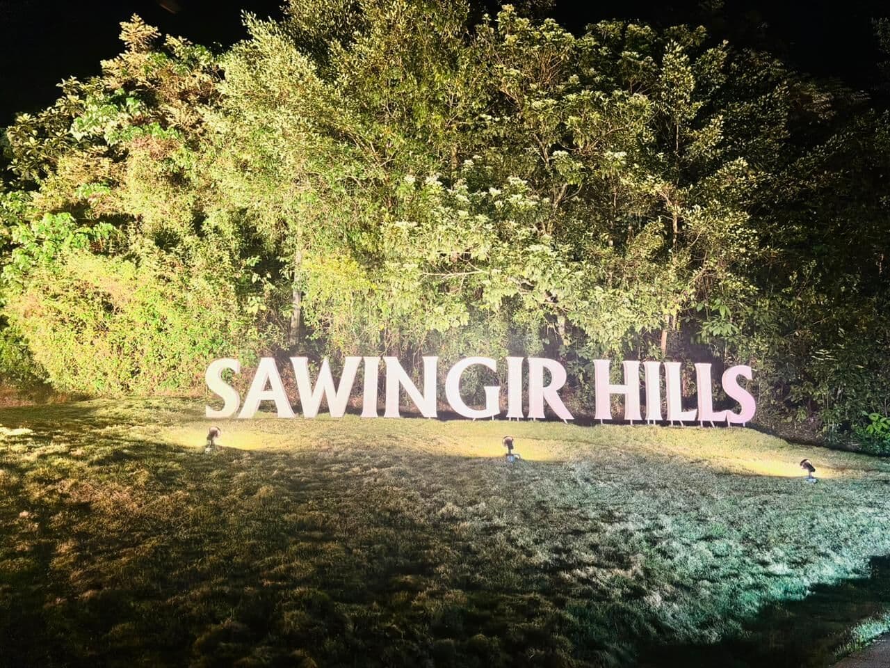 The Sawingir Hills sign lit up at night