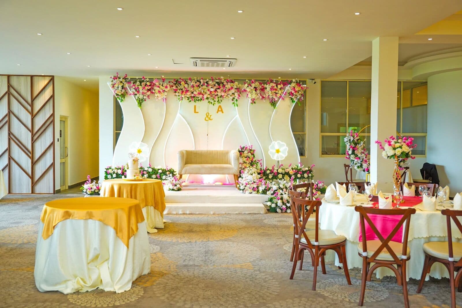 Ambrosia set for a celebration: a flower stage with tables laid in front