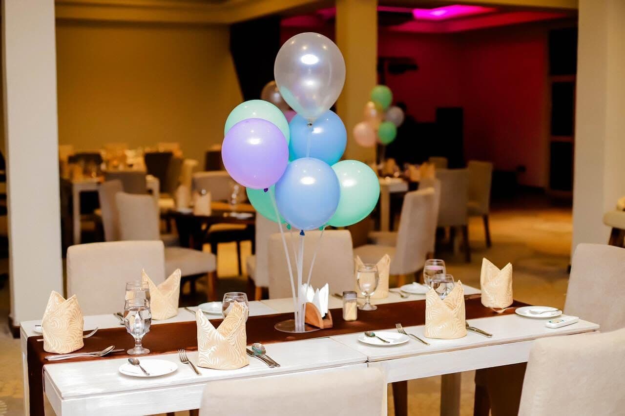 A table in Ambrosia set for a party, with balloons