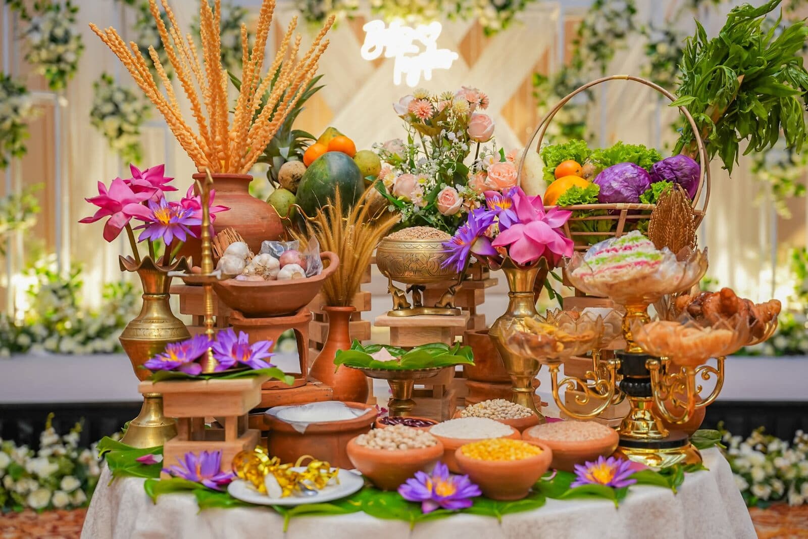 A traditional table of grains, fruit and lotus flowers