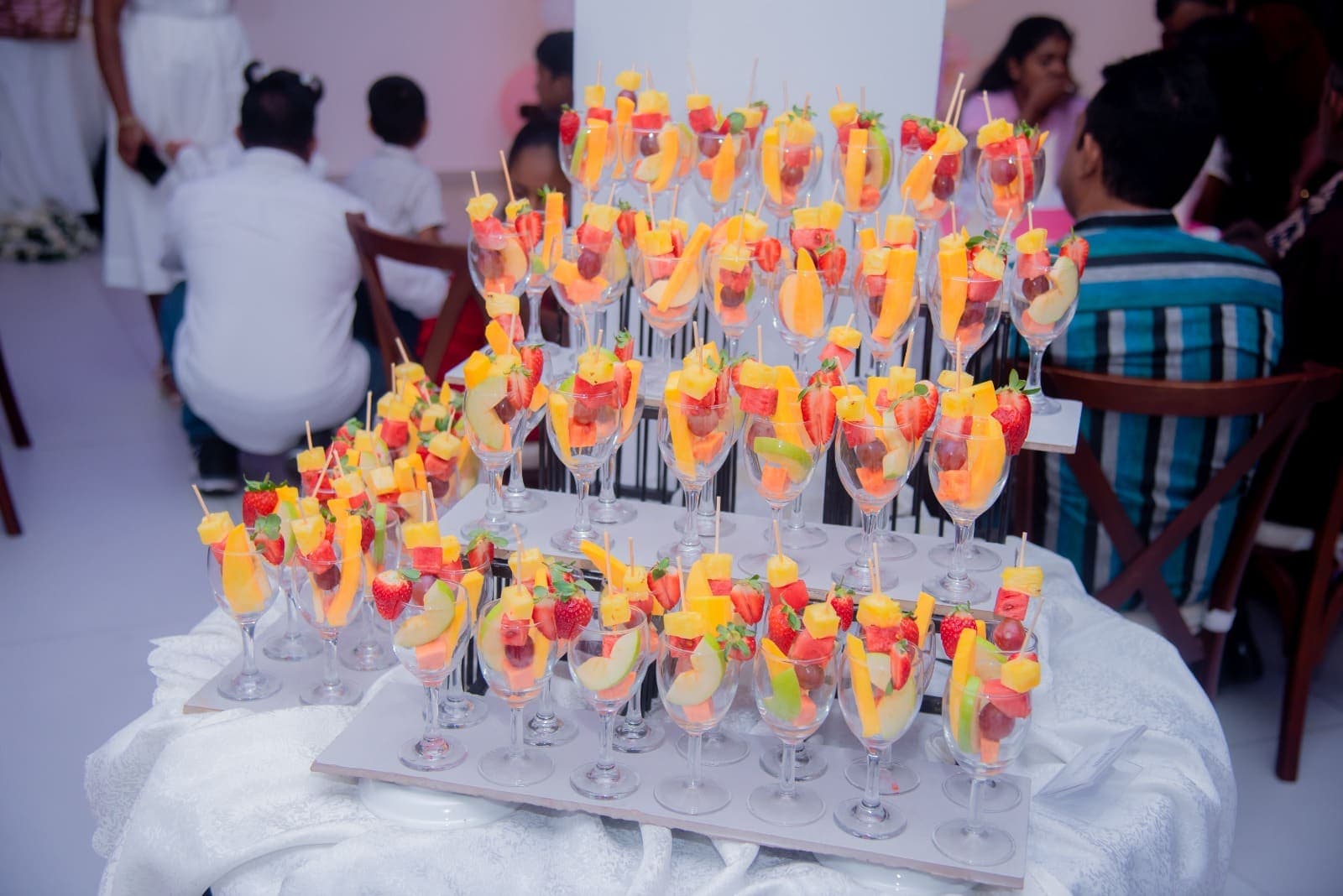 Rows of fruit cocktail glasses on a display stand