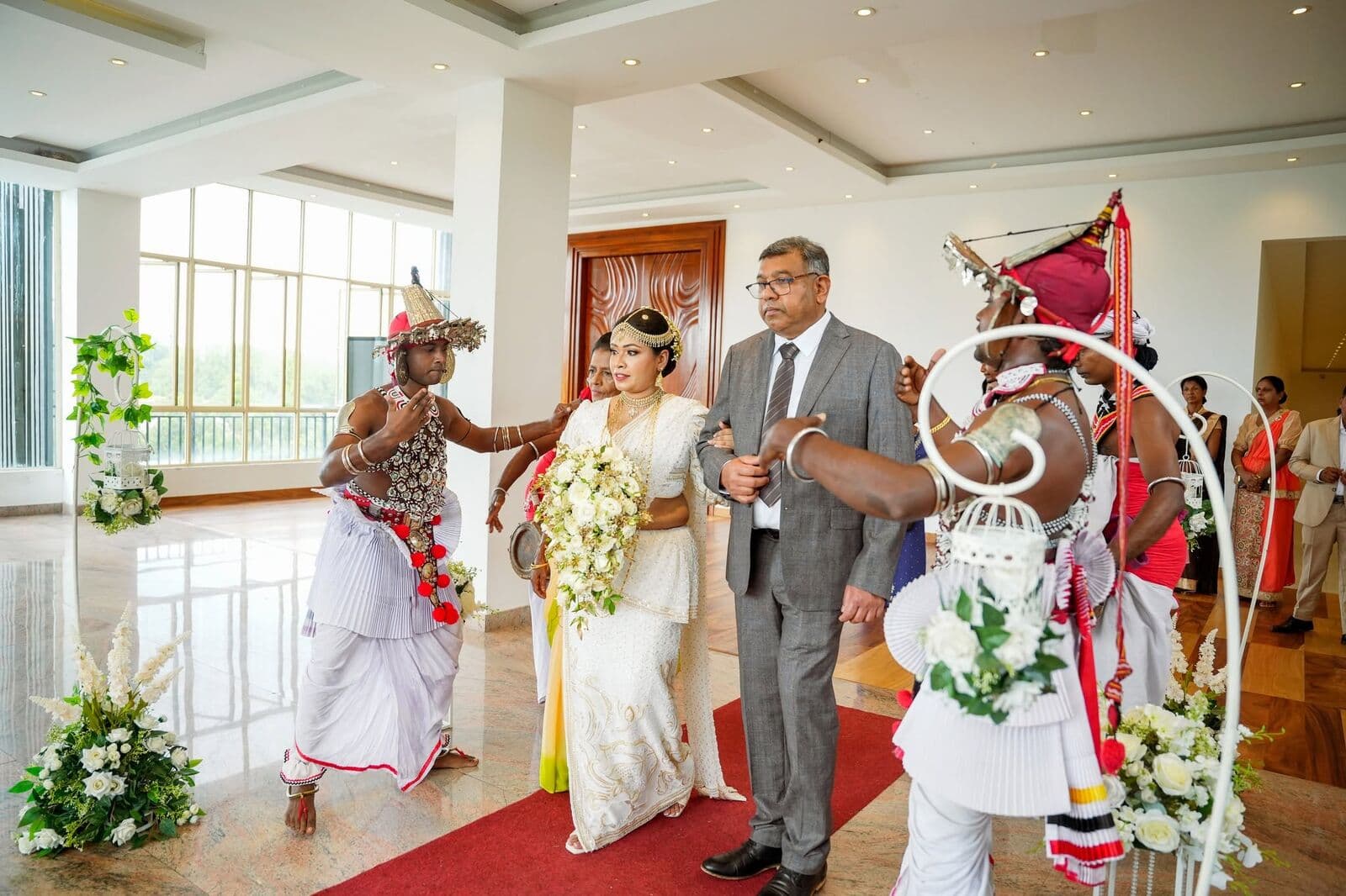 Kandyan drummers and dancers leading a bride and her father into the hotel