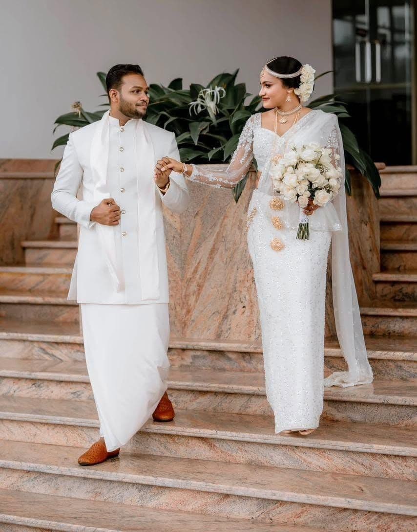 A groom leading the bride down the lobby stairs