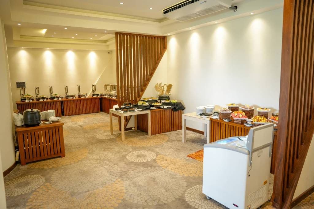 A wedding hall set up with a buffet along the wall
