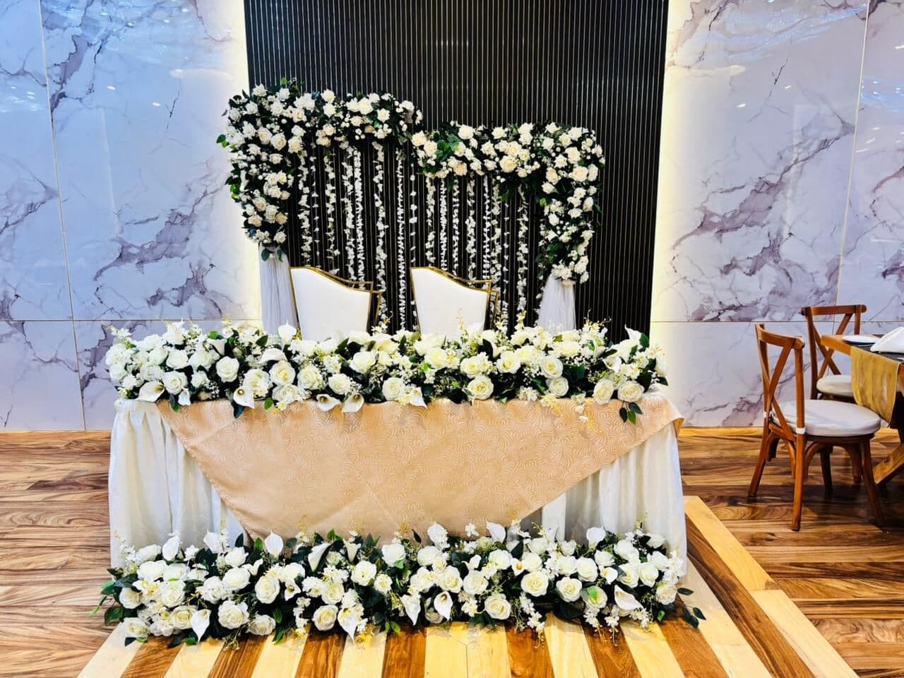 The couple's table in Wisteria, under white flowers