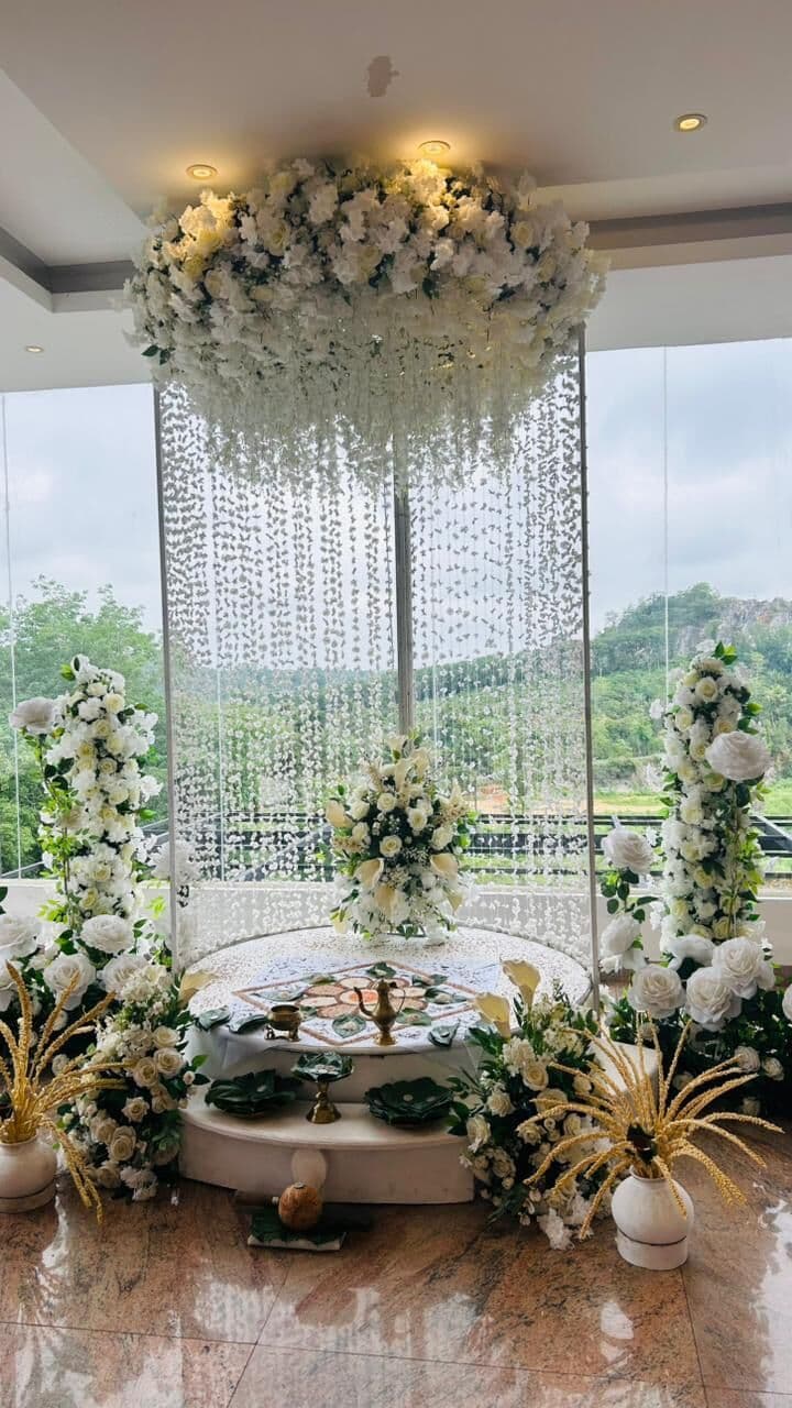 Hanging flower strings at Wisteria's window, with the hills outside