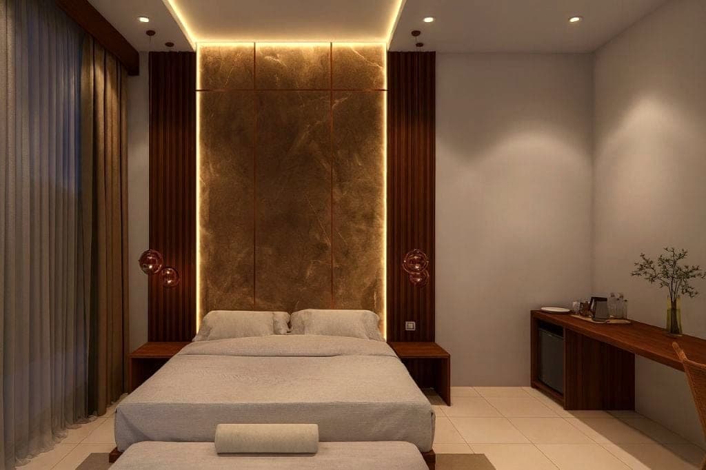A bedroom with a stone-effect headboard wall and bedside lamps